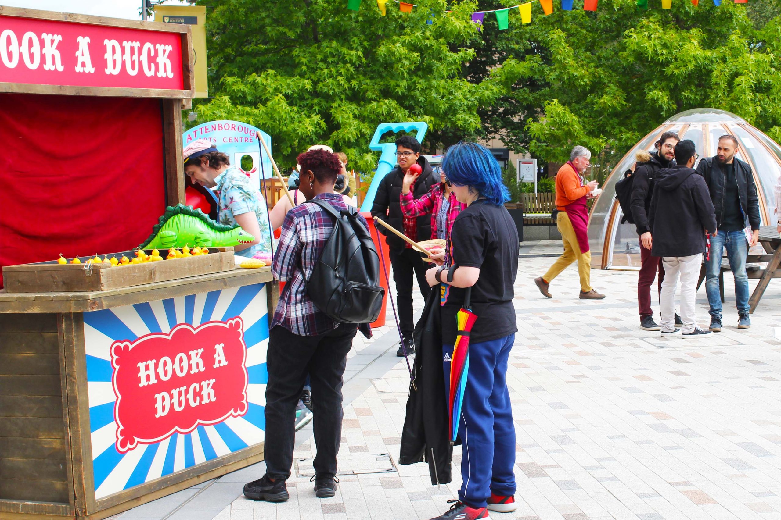 Three students play hook-a-duck together.