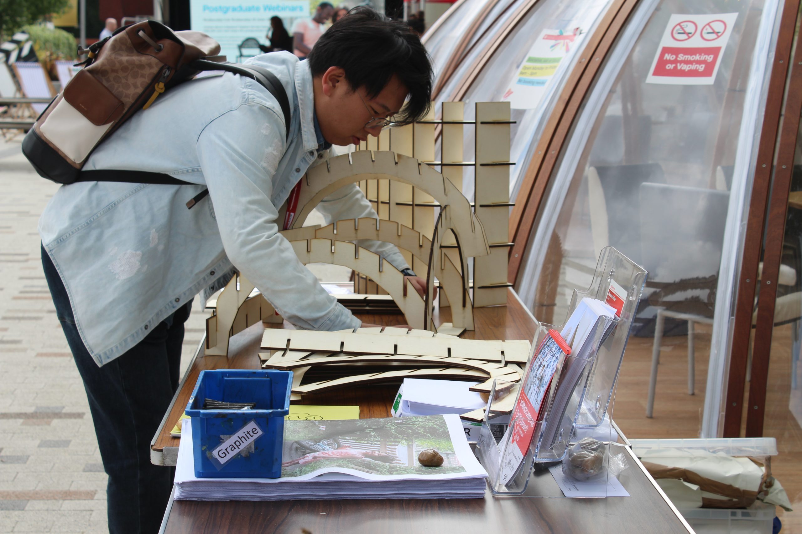 A student building a sculpture designed by Sam Metz.