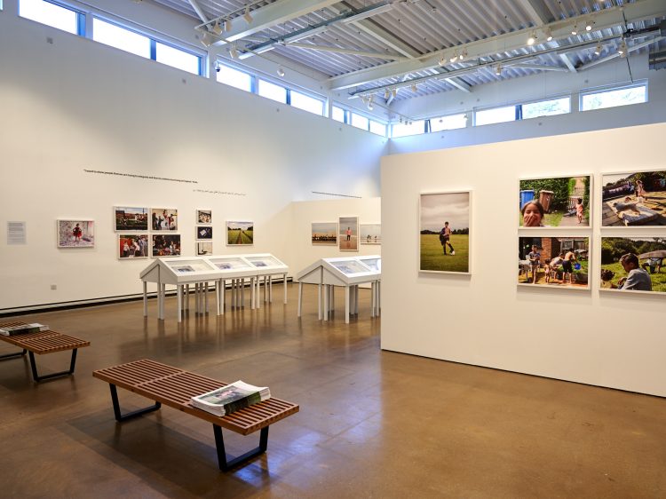 Inside Gallery One, showing an exhibition of photographs on the walls and in display cases.