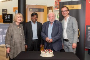 Michael Attenborough cutting cake with University of Leicester and Attenborough Arts Centre