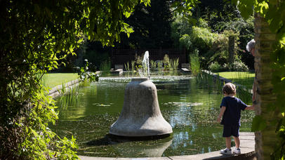 A family enjoy one of the ponds at Botanic Gardens