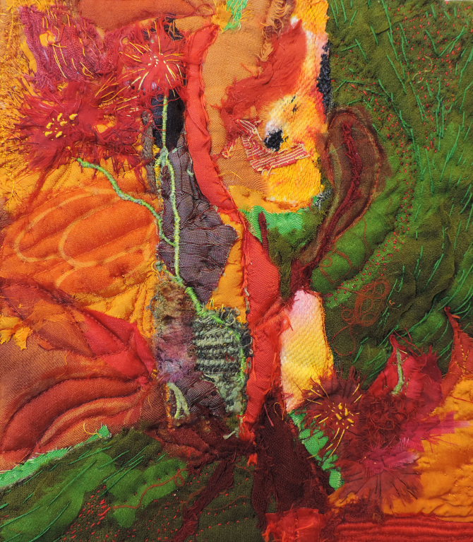 Artwork consisting of sewn material. Reds and oranges to the left and greens to the right.