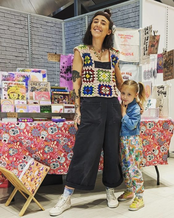 Rosie Johnson with her 5 year old daughter Ramona stood in front of a craft stall.