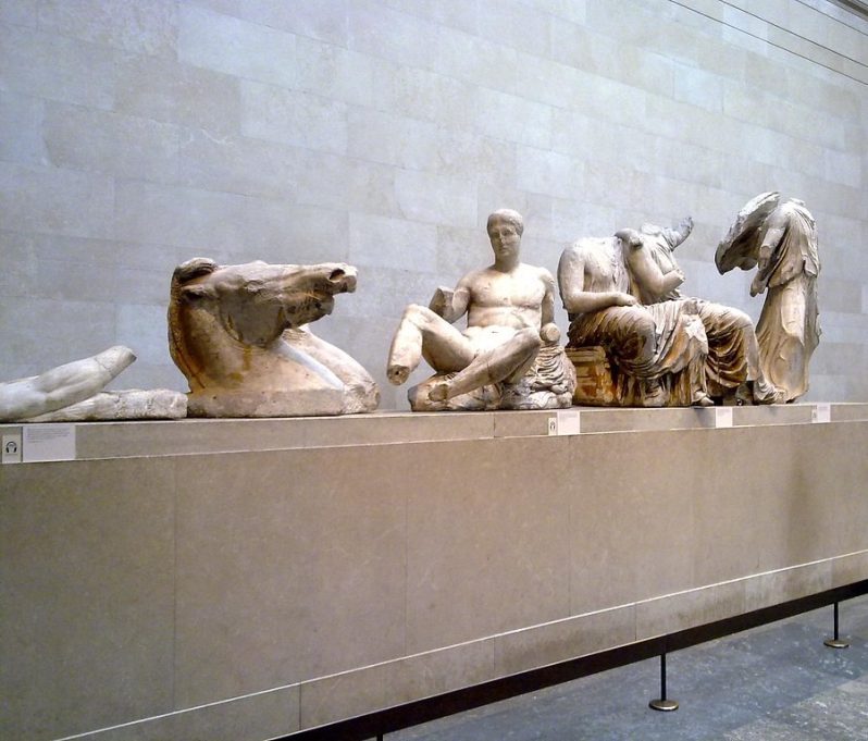 Ancient Greek statues in a stone museum.