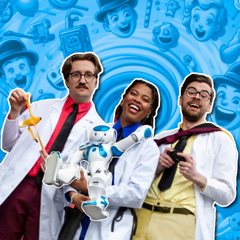 Three people in lab coats holding a toy robot laughing with a blue background toys across it.