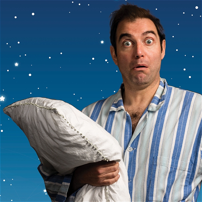 A surprised man in blue striped pyjamas holding a pillow against a starry night.