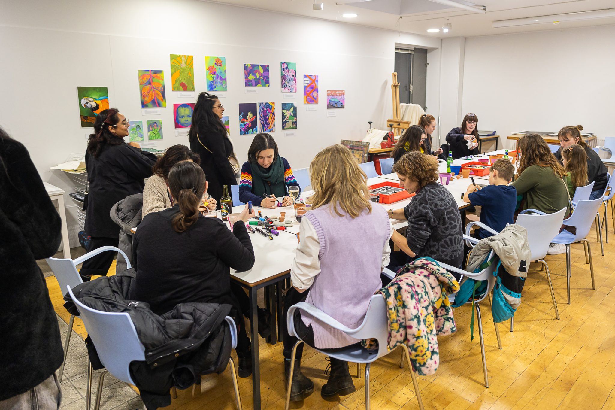 Studio 3 full of people around a table creating with crafting materials.