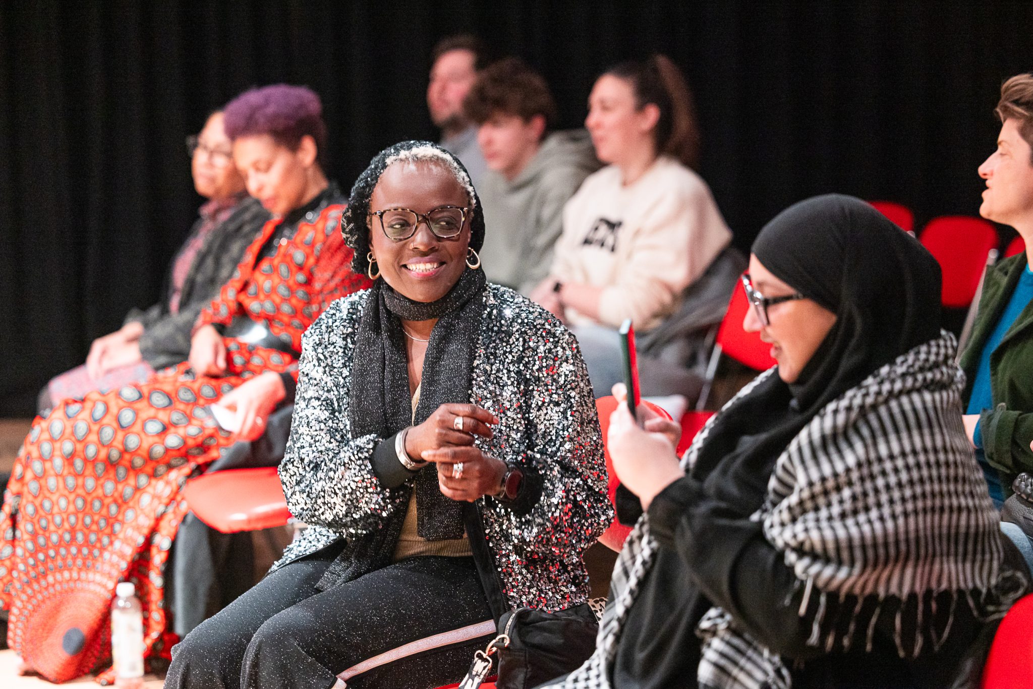 A group of people sat in an audience.