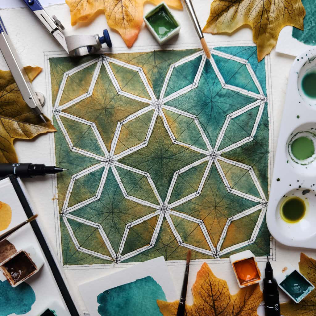 An eight fold octagon pattern painted in watercolours, surrounded by the materials used.
