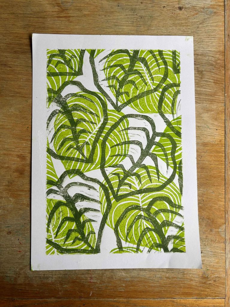 A paper filled with prints of giant leaves.