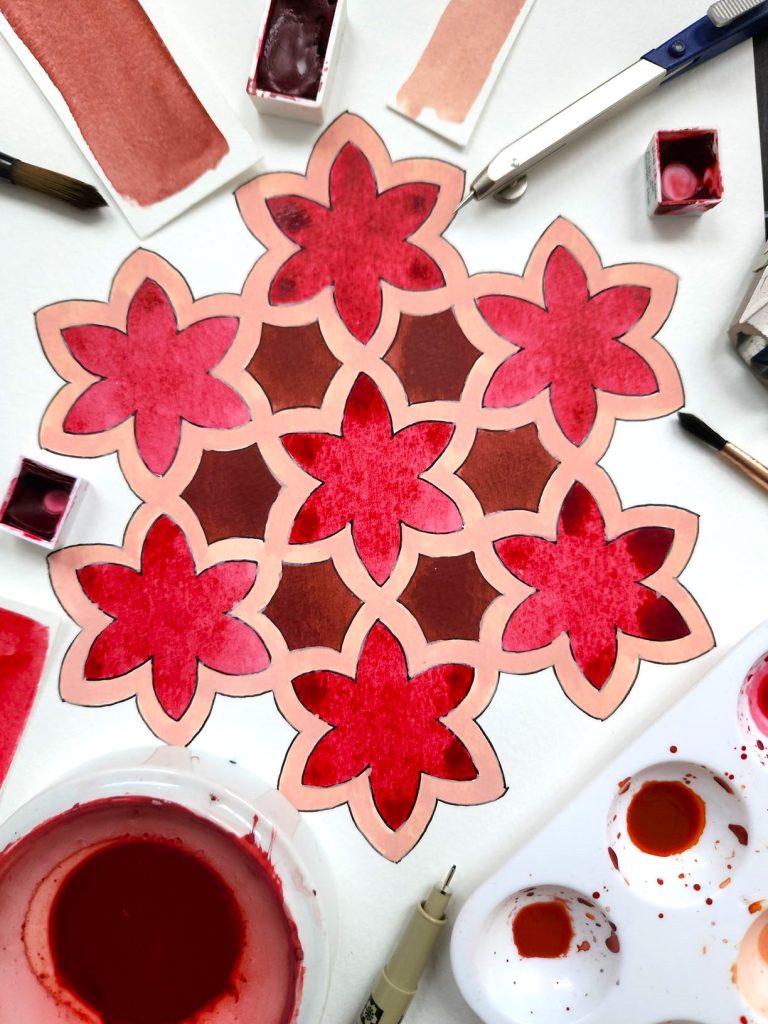 Islamic geometric water coloured pattern of stars in red tones.