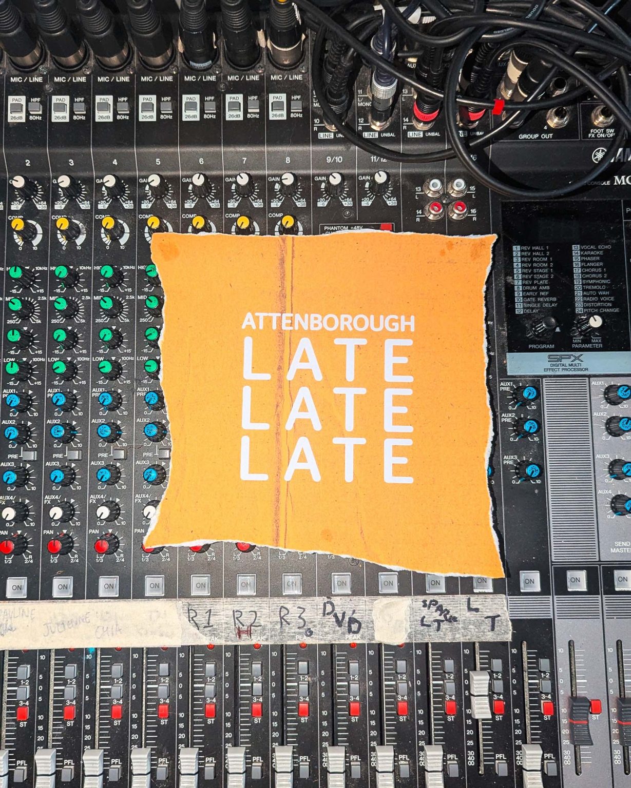 A torn yellow paper saying 'Attenborough Late Late Late' laying on top of a sound board.