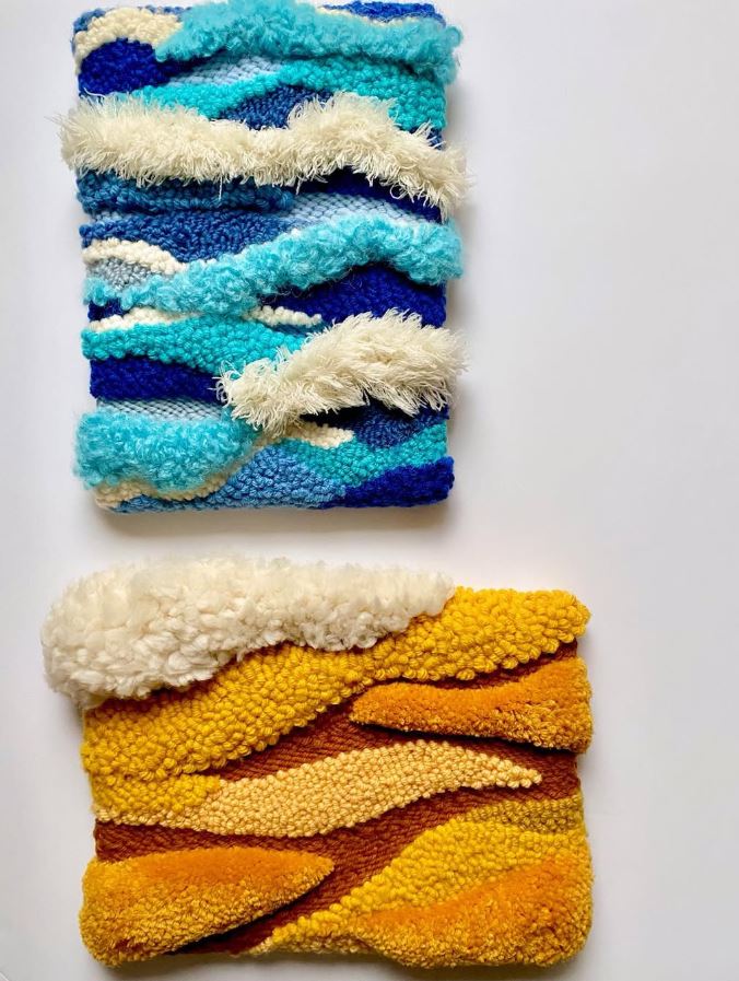 Two rectangle pieces of punch needle wall art displayed on the wall.