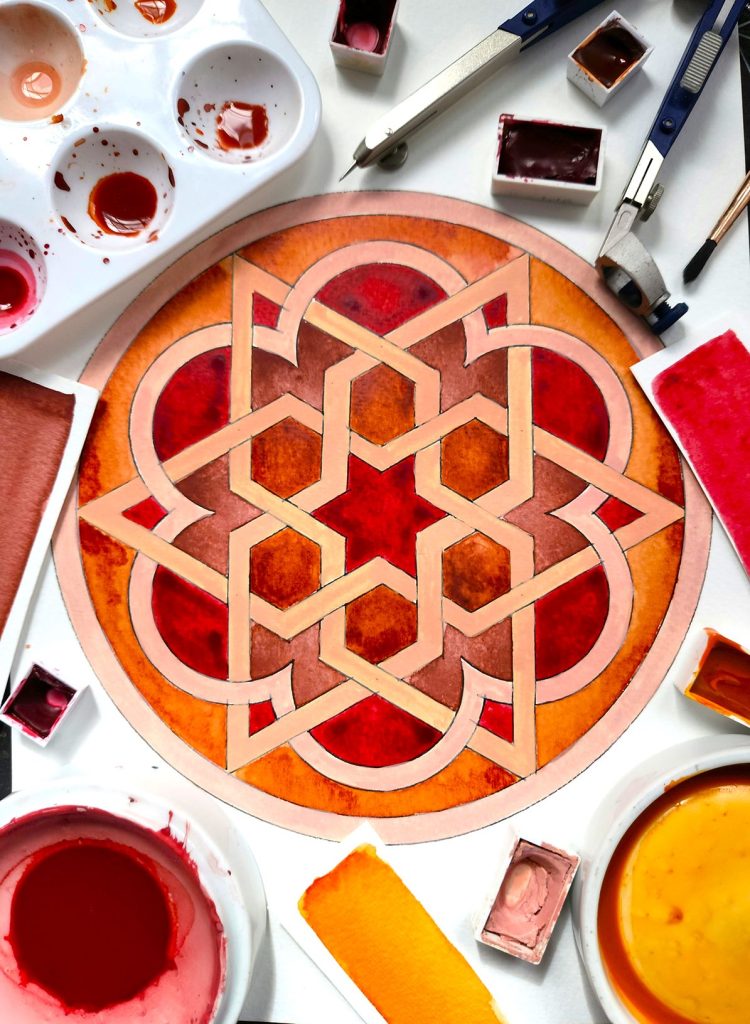 Islamic geometric water coloured pattern in red tones.