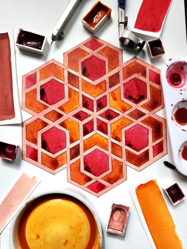 Islamic geometric water coloured pattern in red tones.