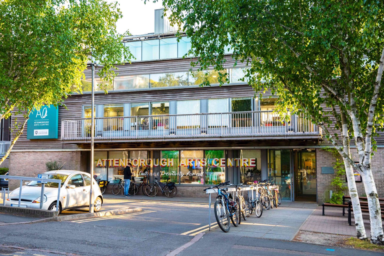 Exterior of Attenborough Arts Centre with greenery in the foreground.